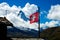 Swiss flag and historic cottages in front of Matterhorn mountain in Switzerland Zermatt