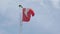 Swiss flag on pole, white cross on red background in slow motion.