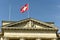 Swiss flag and statue of Justice on Federal Supreme Court of Switzerland. Lausanne, Switzerland