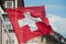 Swiss flag waving in the street in Switzerland