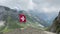 Swiss flag in wind against beautiful mountains at pilatus, Switzerland