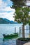 Swiss landscape of beautiful boat moored at the shore of Lake Lugano in Morcote, Switzerland.