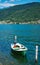 Swiss landscape of beautiful speedboat moored at the shore of Lake Lugano in Morcote, Switzerland.