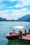 Swiss landscape of luxury speedboat moored at the shore of Lake Lugano in Morcote, Switzerland.