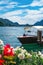 Swiss landscape of luxury speedboat moored at the shore of Lake Lugano in Morcote, Switzerland.