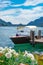 Swiss landscape of luxury speedboat moored at the shore of Lake Lugano in Morcote, Switzerland.