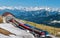 Swiss mountain railways and spring panoramic view of snow-capped mountains in the Alps