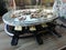 Swiss raclette. A table filled with meat. Raclette machine with a surface for frying and marble plate. Swiss raclette or the Dutch