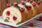 Swiss roll with raspberry and mint close up horizontal