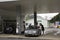 Swiss and traveler people fill oil to tank of car in petrol station
