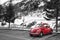 Swiss winter, parking lot by the Alps, red beetle car, beautiful snow mountain