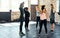 Switch arms. a group focused young people standing in a circle and stretching before a workout session in a gym.