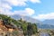 Switchback in paved two lane highway through the Taygetus mountain range on the Peloponnese in Greece with tile roofed houses