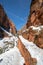 Switchbacks in snow on Angels Landing Hiking Trail during winter in Zion National Park in Utah