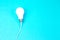 A Switched on light bulb on a light blue background - a symbol of a new idea, innovation