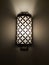 Switched on vintage sconce on a dark wall