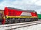 Switcher with train of freight cars in line at a rail yard. Small diesel manoeuvring locomotive