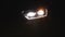 Switching of car LED headlights in night. New modern car headlamp. Car Front Led Light with a Blurry Background. Car