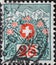 Switzerland - Circa 1910: a postage stamp printed in the Switzerland showing the Swiss coat of arms framed with flowers and high m