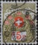 Switzerland - Circa 1911: a postage stamp printed in the Switzerland showing the Swiss coat of arms framed with flowers and high m