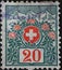 Switzerland - Circa 1911: a postage stamp printed in the Switzerland showing the Swiss coat of arms framed with flowers and high m