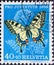 Switzerland - Circa 1954 : a postage stamp printed in the swiss showing a swallowtail butterfly Papilio machaon on wild carrot