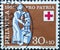 Switzerland - Circa 1957 : a postage stamp printed in the swiss showing a needy and helper. Red cross coat of arms. Federal celebr