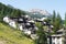 Switzerland, St.Moritz - June 6, 2023: city landscape with buildings, hills and trees, private houses, cottages