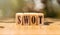 SWOT text in black letters on wooden cubes