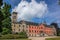 Sychrov Castle with typical pink facade. Neo-Gothic style chateau with beautiful english style park in summer. Bohemian