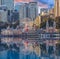 Sydney Harbour Australia at Sunset with the reflection of the Buildings and high rise offices of the City in the water