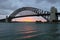 Sydney Harbour Bridge at sunset by clouded sky