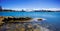 Sydney Harbour with nice rocks in the foreground and the beautiful harbour foreshore as a backdrop NSW Australia