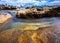 Sydney Harbour with nice rocks in the foreground and the beautiful harbour foreshore as a backdrop NSW Australia