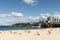 Sydney, NSW/Australia: Bondi Beach with the Iceberg Pool in the background and the surfers