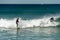 Sydney, NSW/Australia: Bondi Beach with the Iceberg Pool in the background and the surfers