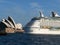 Sydney Opera House with huge cruise ship passing past out to the open sea