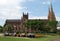 Sydney residents and tourists enjoying midday on the benches of Hyde park in front of St. Mary`s Cathedral