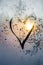 Symbol of beautiful heart with the sun inside painted on misted glass, moonlight, texture of frost and water drops, empty space