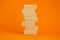 Symbol of building success foundation. Wooden blocks on the stack of wooden blocks. Beautiful orange background, copy space.