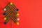 Symbol Christmas tree made of stationery, paper clips, office supplies on red background. new year`s concept in office