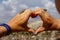 Symbol of heart made up of womens fingers through it is seen Cappadocia