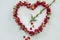 Symbol heart from roses pierced by Cupid\'s arrow