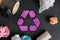 symbol or icon of recycling, top view flat lay with some garbage s