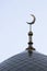 The symbol of Islam is a golden crescent moon on a blue evening or morning sky. The top of the mosque minaret. Vertical picture.