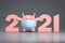Symbol of new 2021 year Pink bull or cow figure as Piggy Bank in face medical surgical mask save money - christmas card