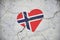 The symbol of the Norway national flag in the shape of a heart, on a cracked concrete wall