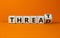 Symbol for online hate. Turned a cube and changed the word `threat` to `thread`. Beautiful orange background. Concept. Copy sp