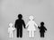 Symbol of a person and family cut out of black and white paper. Interracial family. Space for text. mixed race marriage