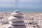 Symbol Scales is made of stones of various shapes. Balance of stones. Balancing stones on the shore. Tourism, travel.